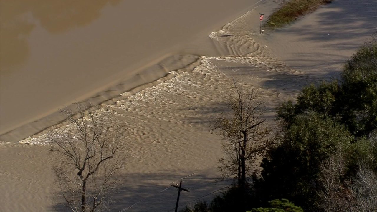 Water covers road near East Fork of San Jacinto River as...